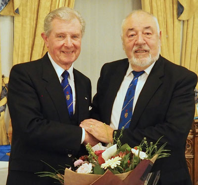 Ian Fowler (right) presenting Stuart Thornber with a gift of flowers from the lodge.