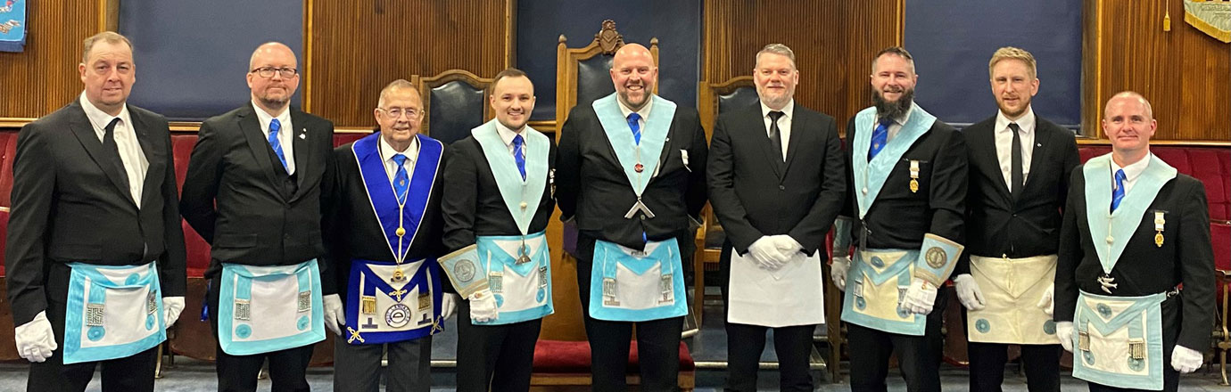 Light blue members of Carnarvon Lodge with Chris Upton and Stuart Macfarlane (centre).