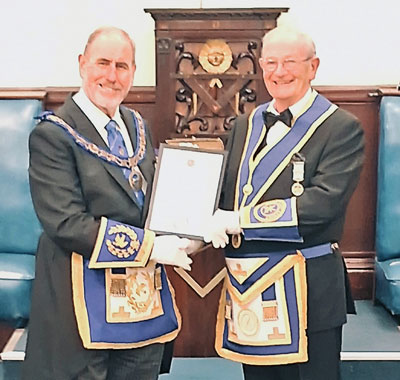 Frank Pointon pictures as he receives his certificate from Frank Umbers 