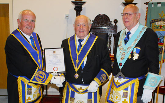 Phil Holland (centre) receives his 50th anniversary certificate from Patrick Walsh (left) with Noel Grubb (right).