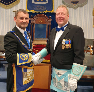 David Thomas (left) congratulates Andy Greenlees on being installed into the chair of Royal Oak Lodge.