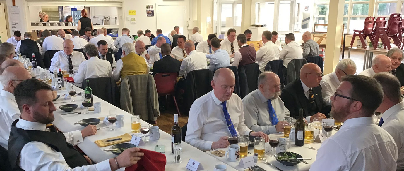 Brethren and guests assembled in the school dining room.