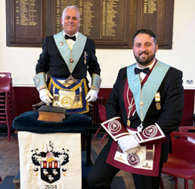 John Topping (left) being congratulated by his son David Jenkinson, South Fylde Group Charity Steward.