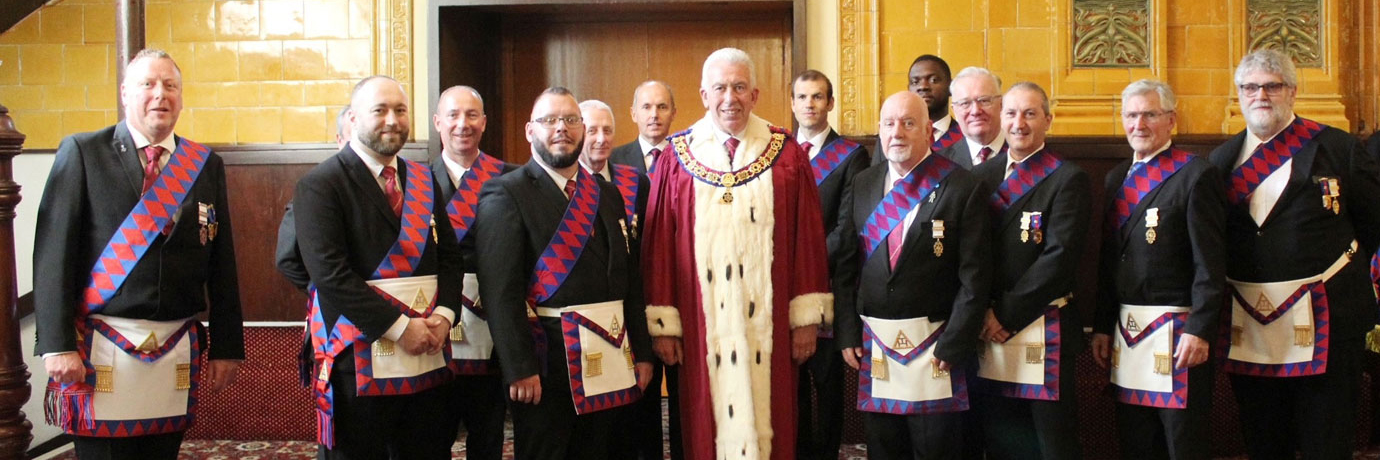 Mark Matthews (centre) welcomes the newly exalted companions.