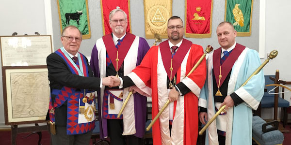 Pictured from left to right, are: Colin Rowling congratulating the three principals Sandy Kean, Graham Barker and David Mitton. 