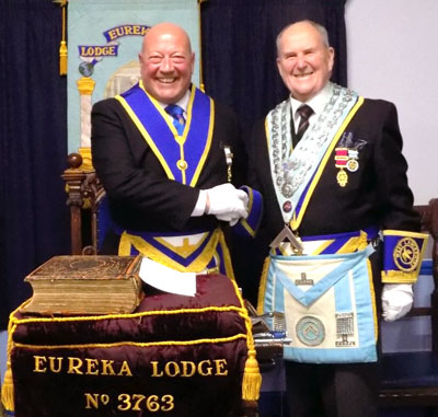 Don Fraser (right) congratulates the new master of the lodge David Seel.