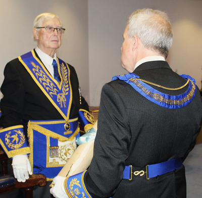 Brian Hayes (left) solemnly hands the lodge warrant to Stuart Boyd.