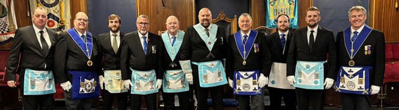 Visitors from other light blue clubs with new member Neil Ward (second left), worshipful master Chris Upton (centre) and guest talker Eric Kos (fourth right).