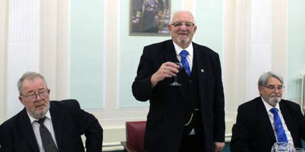 Eric Palfreyman (centre) leads the toast to the visitors.