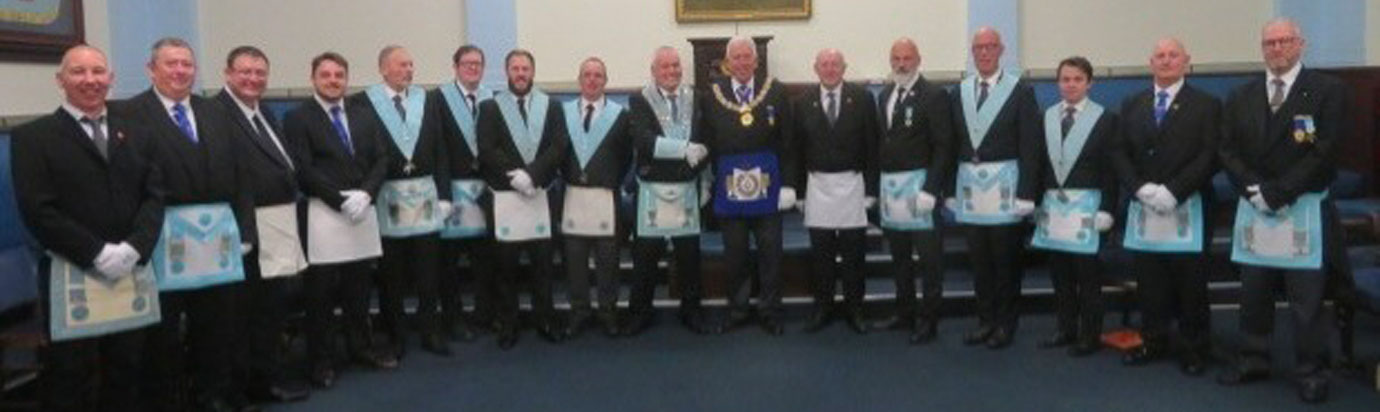 Pictured central, Mark congratulating Robert Woodiwiss, surrounded by some of his team and the large number of entered apprentices, fellow craft and master Mason light blues in attendance from Perfect Ashlar Lodge and the wider group.