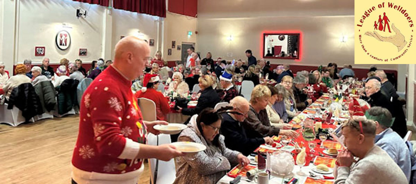 Brian Gillbanks (left) serves the first course of the Christmas Dinner. Inset: The League of Welldoers logo.