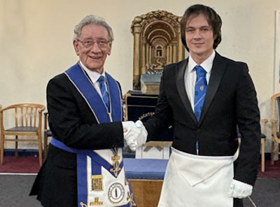 Malcolm Sandywell (left) congratulates Karl on his initiation.