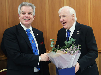 Stuart (left) receiving flowers for his wife from John Hutton.