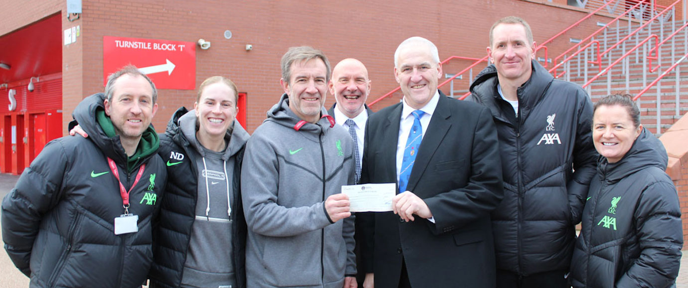 Andy Whittle (third right) presents a cheque to the team.