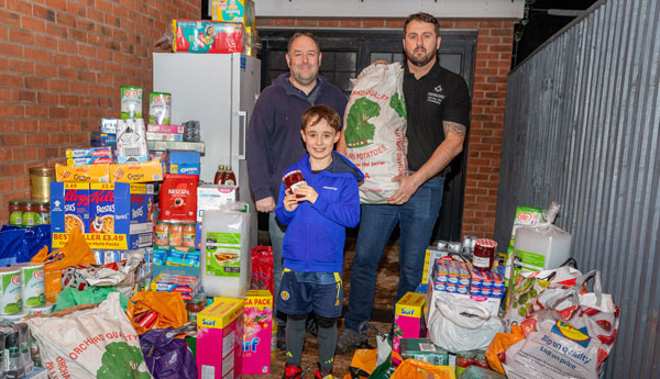 Pictured from left to right, are: Ben Gorry, Arran Gorry and David Jenkinson storing the supplies in the secure lockup