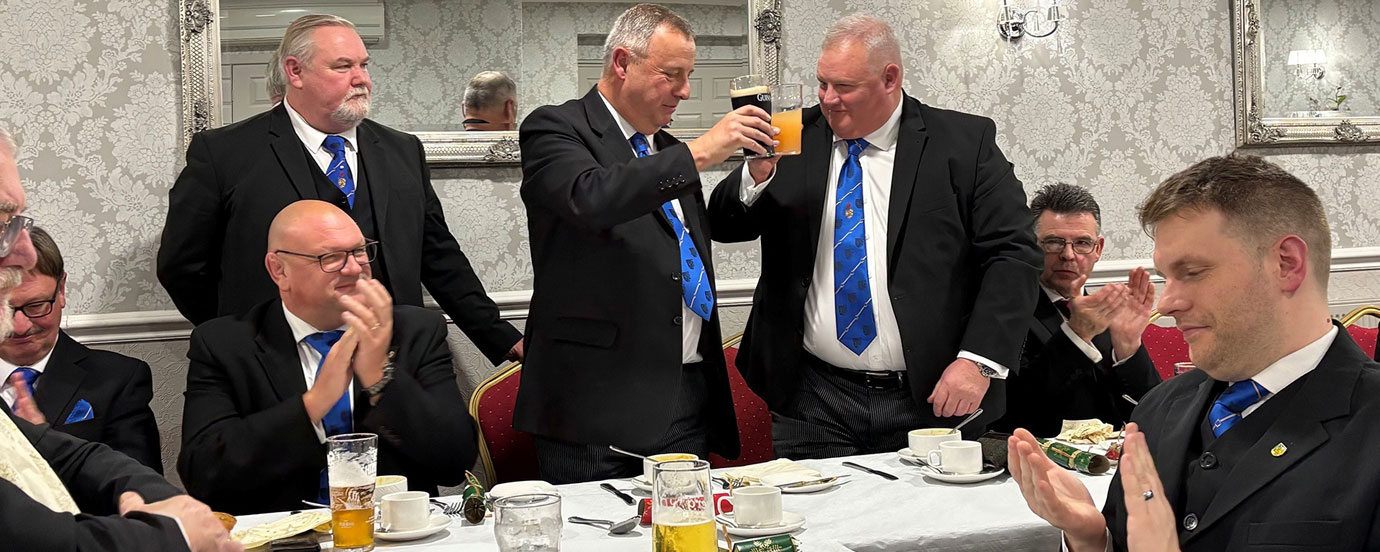 Peter Lockett (standing centre) toasting Stephen Gerrard who led the closing ceremony.