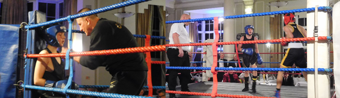 Pictured left: A young boxer takes a breather between rounds. Pictured right: Two competitors size each other up.