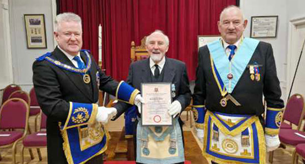 Pictured from left to right, are: Peter Scofield, presenting Derek Adams (centre) with his diamond jubilee citation and David Cole (WM).