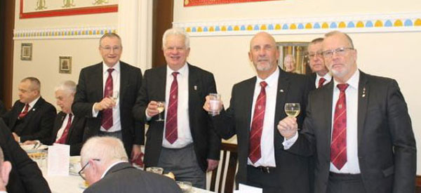 A toast to the new principals from Ian (left), under the watchful eye of the chapter DC Dave Brighouse.