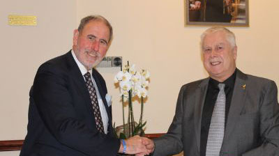 Dave Johnson (right) presents a gift from the group to Frank Umbers.