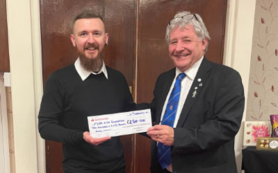 Keith Carter (right) presents a cheque to Tom Wyatt.