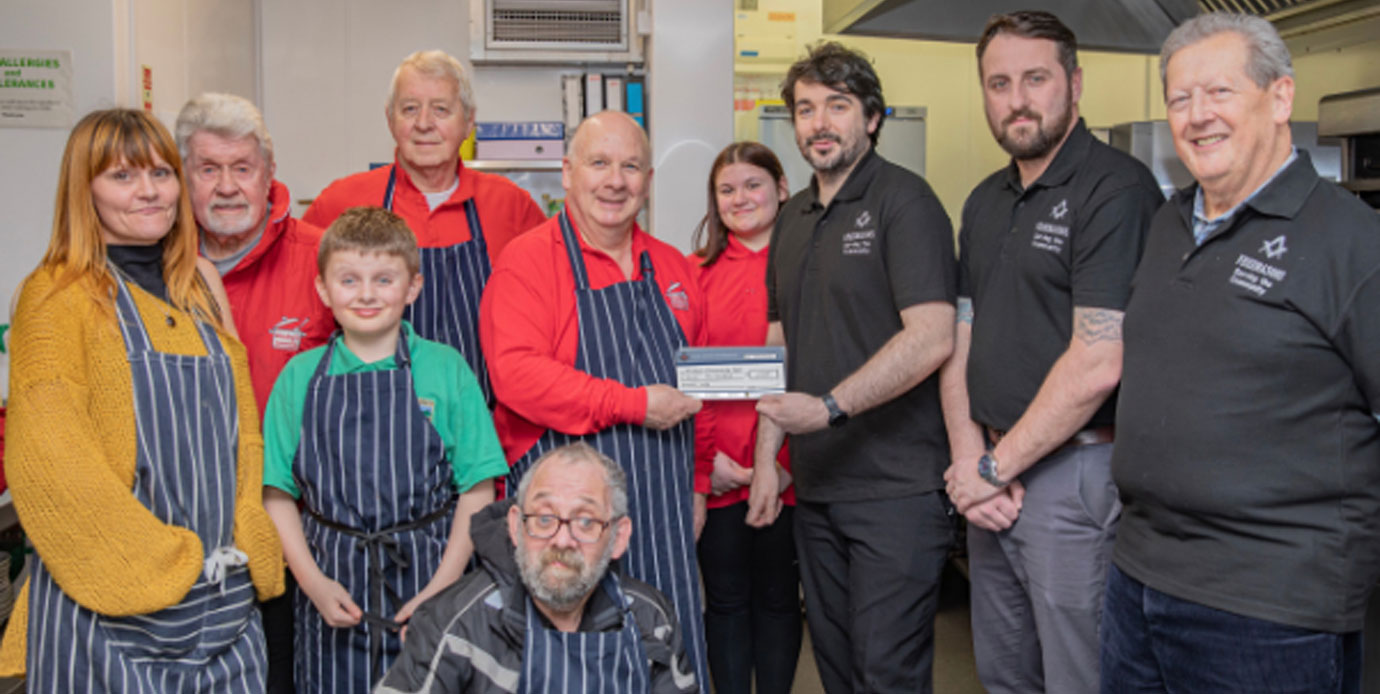 Jon Boriss presenting the ‘GINgle’ cheque to Robert Bentwood supported by other helpers. Pictured left to right, are: Joanna Roberts, Geoff Crosland, Oscar Burns, Paul Caddy, Robert Bentwood, Lily Mae Woods, Jon Boriss, deputy group charity steward, David Jenkinson, Tony Smith and Russell Fieldsend (kneeling).