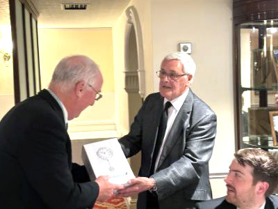 Ray Erskine (right) presents Alan Morris with a commemorative clock in celebration of his golden jubilee. Ray Erskine (right) presents Alan Morris with a commemorative clock in celebration of his golden jubilee.