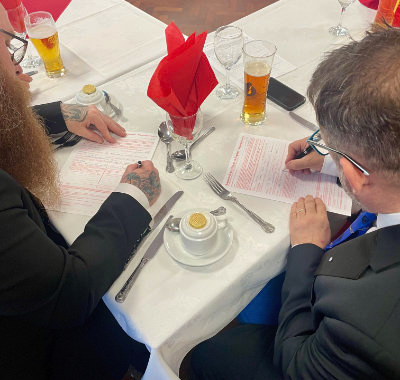 The candidates complete their application forms before dinner is served.
