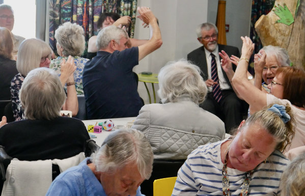 Assistant Provincial Grand Master David Barr (seated right) enjoying chair disco with centre members.
