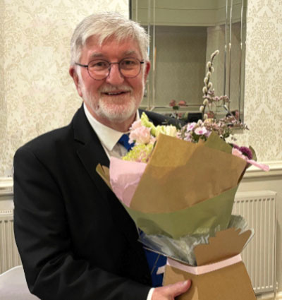 John Robson with flowers from the lodge for Mrs Robson.