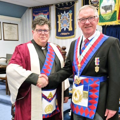 Reverend John Hall (left), congratulated by John Robbie Porter.