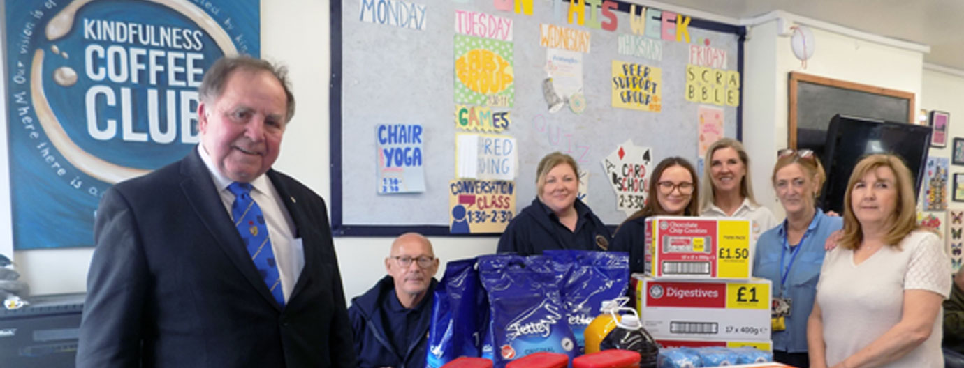 Graham presents supplies to volunteers and part time staff at the Kindfullness Coffee Club, Bootle.