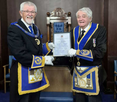 David Barr (left) presents Glyn Lloyd with his certificate celebrating 50 years in the Craft.