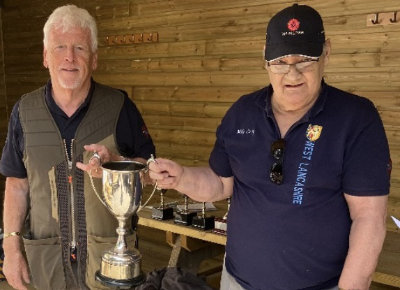 High Gun winner Dave Smith (left) receiving the High Gun Trophy from Mike Casey.