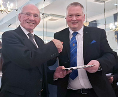 Peter McPhail (right) presents the silver salver to Geoff Wilcock.