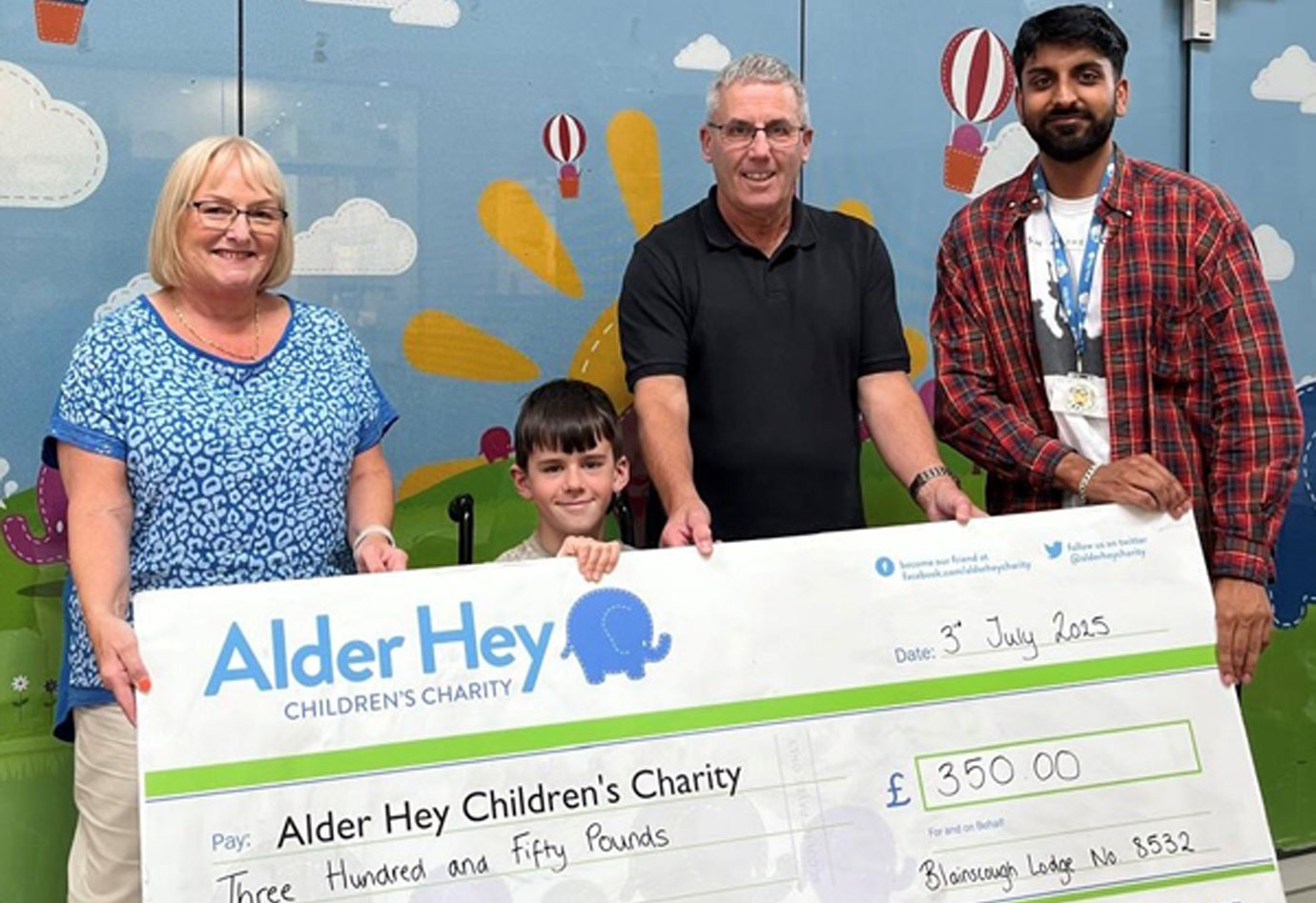 Pictured from left to right, are: Elaine Corner, Archie and Stephen Corner hand over the cheque to one of the many Alder Hey Charity members.