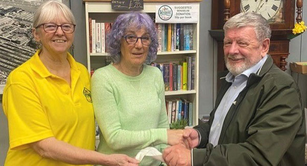Pictured from left to right, are: Heather and Barbara receiving the donation from John.