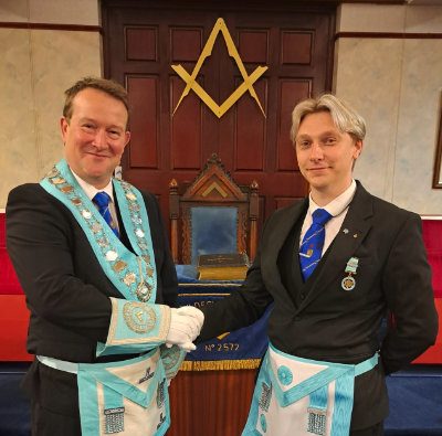 WM David Peacock (left) congratulating Martin Aldred on being raised to a master Mason.