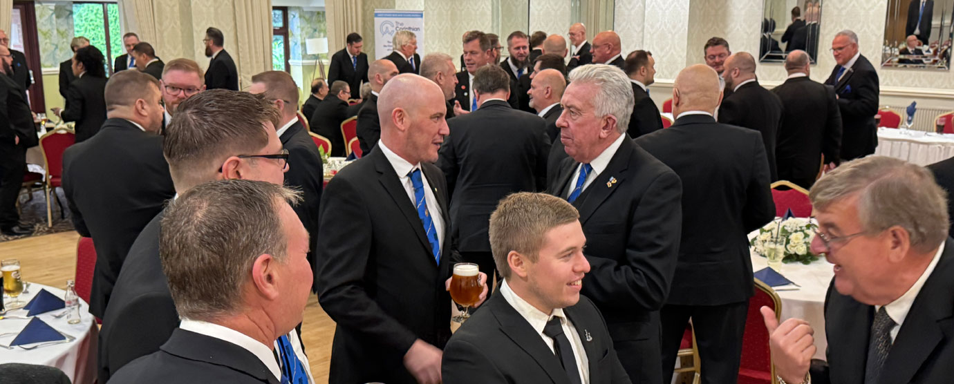 Mark chats with light blue members at the festive board.