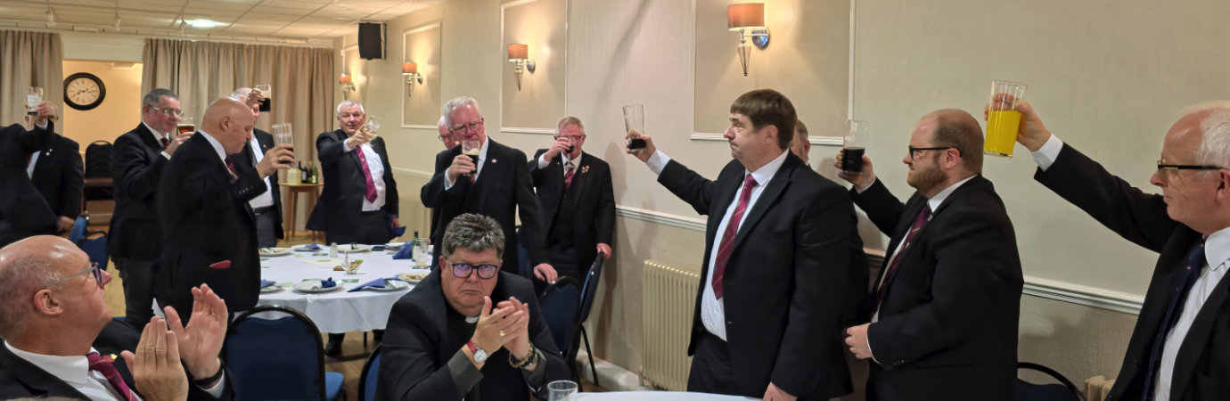 The three principals (right) toast the companions of the demonstration team.