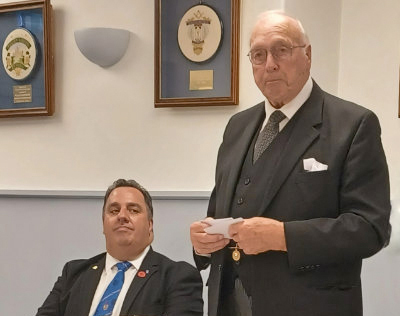 Michael Tax (seated) listening to Mike Lamerton make hie reply.