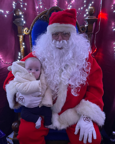 John Lennon (Santa) with his youngest visitor.