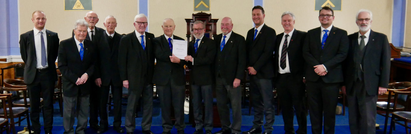 Members of Rectitude Lodge with Bob Marsden (centre right) presenting a lodge 50th certificate to John Fadden (centre left).