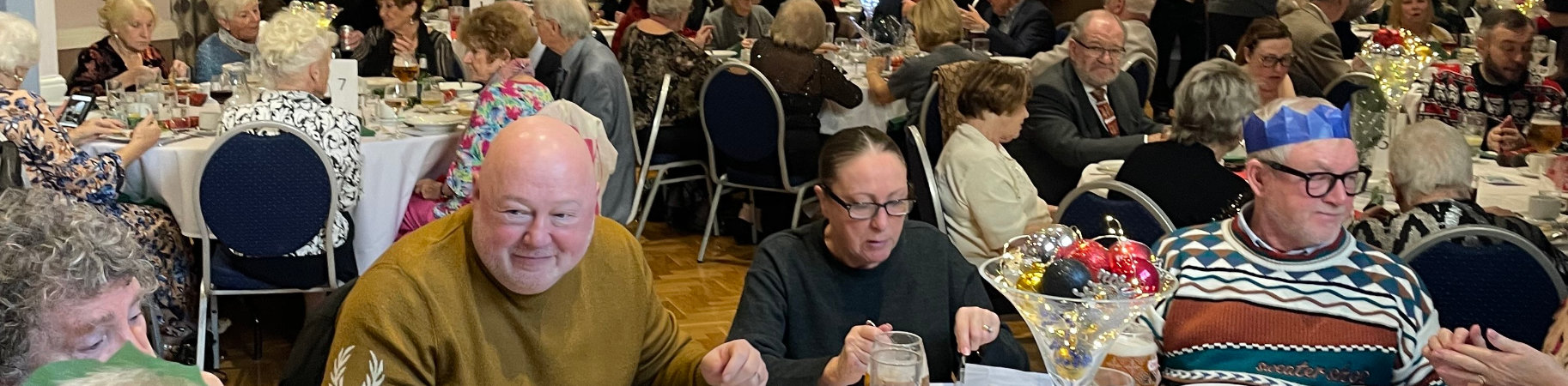 A packed hall of diners enjoying their Christmas lunch.