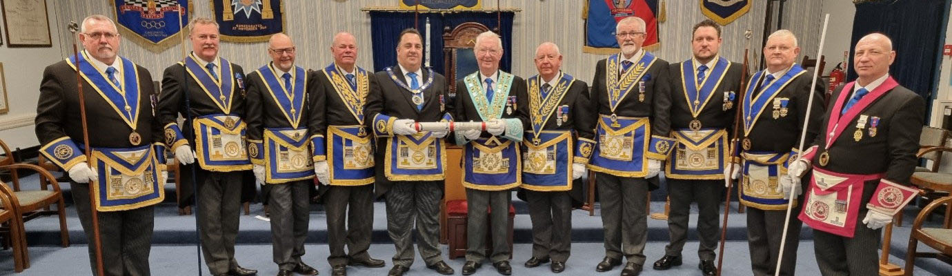 Michael Tax (centre left) with the master of Tithebarn Lodge Keith Jackson holding the warrant of the lodge, along with grand officers and acting Provincial grand officers and North Fylde Group Chairman John Cross (third left)