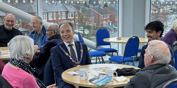 A shared moment of connection between Jonathan Heaton (centre) of West Lancashire Freemasons and former PNE player Alex Bruce (right) at Creating Connections.