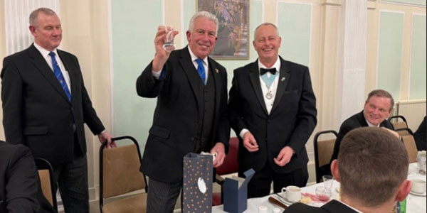 Pictured from left to right, are: Ian Halsall and Mark Matthews being presented with a firing glass from Peter Lewis.