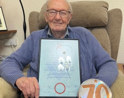 Alan Bamber with his certificate celebrating 70 years in Freemasonry