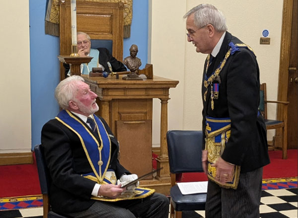 John Lockley (right) presents the certificate to Bernard Bailey.