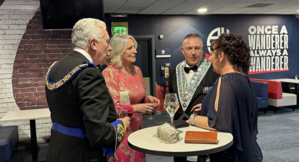 Mark and Debbie (left0 welcome their guests.